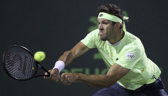 Jiri Vesely, of the Czech Republic, returns the ball to Jack Sock, of the United States, during the Miami Open tennis tournament, Sunday, March 26, 2017, in Key Biscayne, Fla. (AP Photo/Luis M. Alvare ...