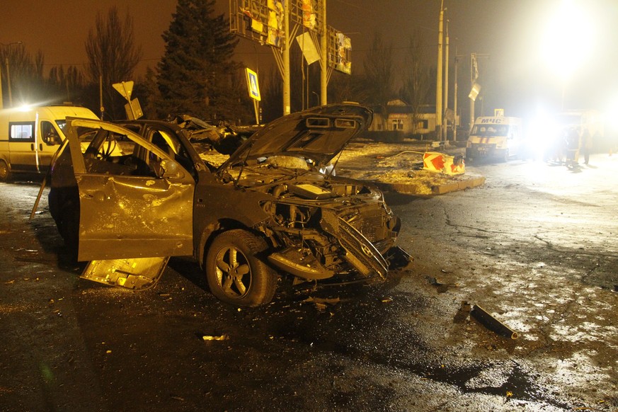 A car lies damaged on a street after artilley shook Donetsk, eastern Ukraine, late Thursday, Feb. 2, 2017. Salvos of artillery shook eastern Ukraine on Thursday, the fifth day of escalated fighting be ...