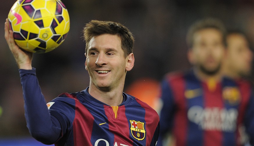 FILE - In this Sunday, Dec. 7, 2014 file photo, FC Barcelona&#039;s Lionel Messi holds the ball after scoring a hat-trick in the Spanish La Liga soccer match against Espanyol at the Camp Nou stadium i ...