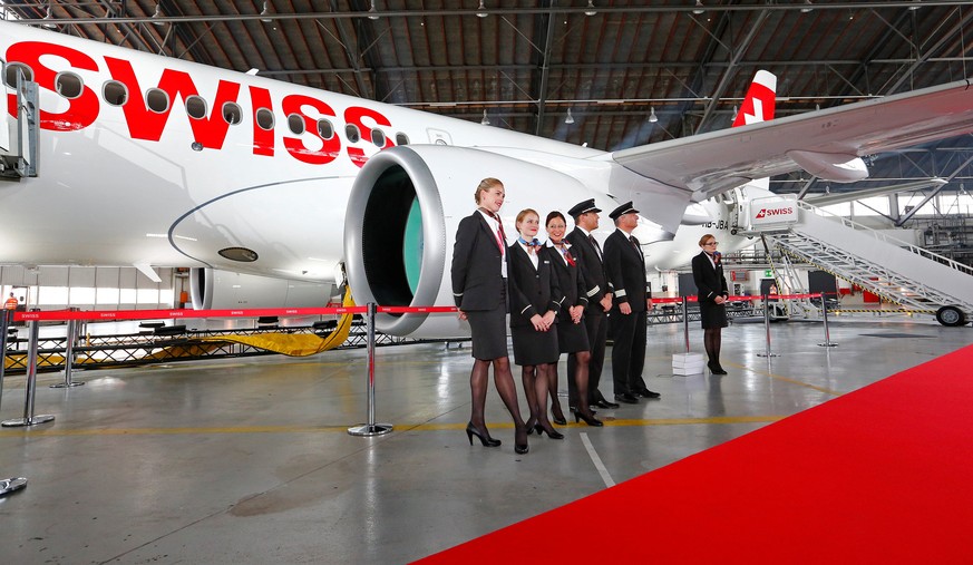 Crew members of Lufthansa unit Swiss International Air Lines stand in front of the airlines&#039; new Bombardier CS100 aircraft during a media presentation at Zurich airport, Switzerland July 6, 2016. ...