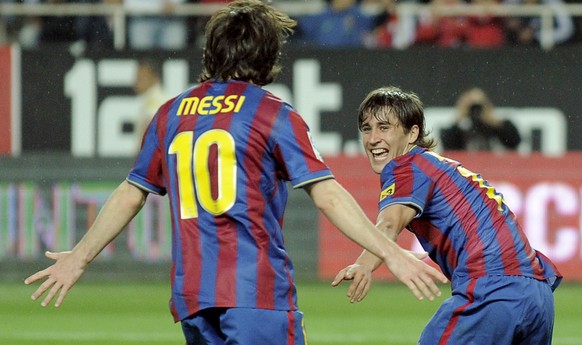 Barcelona&#039;s Bojan Krkic, right, celebrates with team mate Lionel Messi of Argentina after scoring a goal against Sevilla during his La Liga soccer match at the Ramon Sanchez Pizjuan Stadium in Se ...