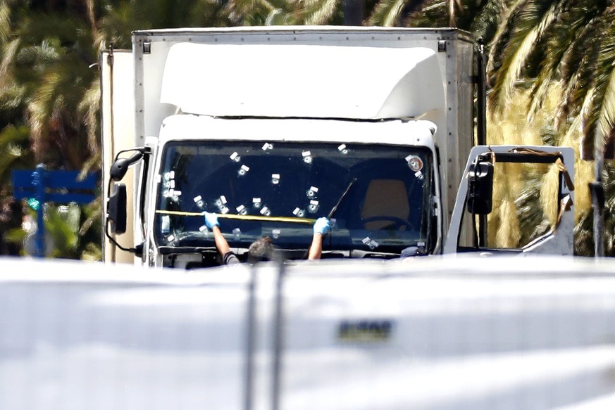 epa05426093 Crime scene investigator works on the truck which crashed into the crowd during the Bastille Day celebrations in Nice, France, 15 July 2016. French government announce a three days of nati ...