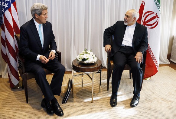 U.S. Secretary of State John Kerry sits with Iranian Foreign Minister Mohammad Javad Zarif before a meeting in Geneva January 14, 2015. Zarif said on Wednesday that his meeting with Kerry was importan ...