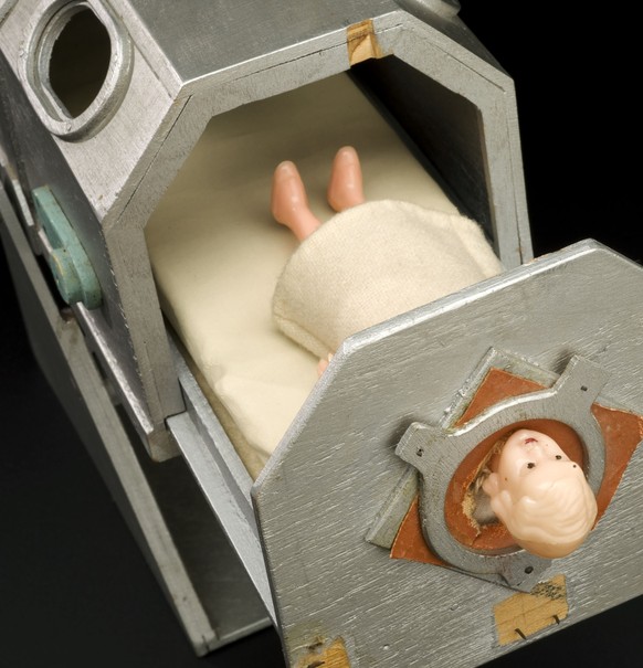 UNITED KINGDOM - JULY 15: Teaching doll showing an iron lung. England, 1930-50. Wooden model of an iron lung, with plastic infant doll and bedding enclosed. Probably used to demonstrate to child patie ...