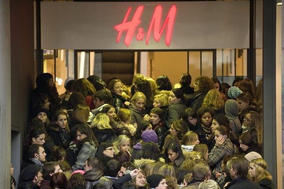 Shoppers wait to go inside the Hennes &amp; Mauritz, H&amp;M fashion shop during the launch for the Jimmy Choo designer clothes and shoes released at the store in Lausanne, Switzerland, Saturday, Nove ...