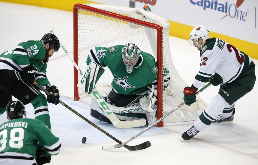 Dallas Stars&#039; Lauri Korpikoski (38), of Finland, and Jordie Benn (24) help goalie Kari Lehtonen (32), of Finland, defend against pressure at the net by Minnesota Wild&#039;s Nino Niederreiter (22 ...