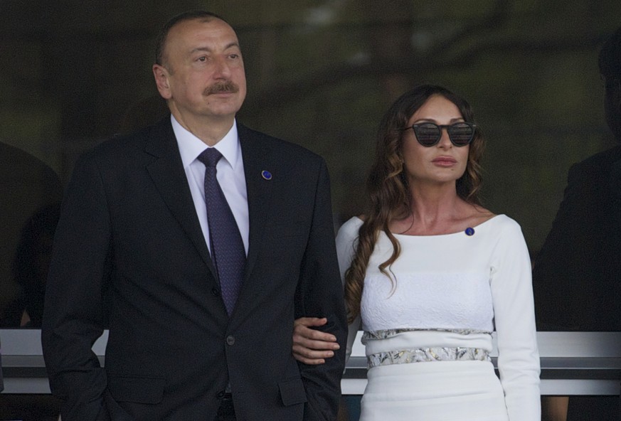 FILE - In this Sunday, June 19, 2016 file photo, Azerbaijan&#039;s President Ilham Aliyev and his wife Mehriban Aliyeva watch the last minutes of the Formula One Grand Prix of Europe at the Baku Circu ...