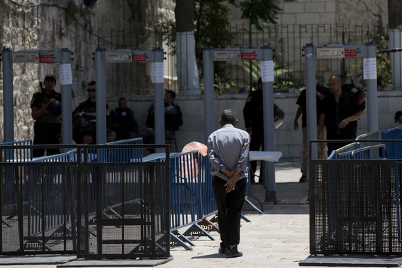 A Palestinian man walks towards a metal detector at the Al Aqsa Mosque compound in Jerusalem&#039;s Old City, Wednesday, July 19, 2017. A dispute over metal detectors has escalated into a new showdown ...