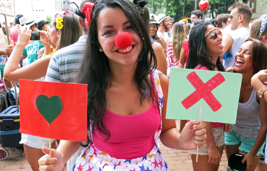 Luiza Rocha, a 22-year-old university student, holds up placards with symbols used on the hookup app Tinder at the Tinder-themed debut street party &quot;Match Comigo&quot; in Rio de Janeiro, Brazil,  ...