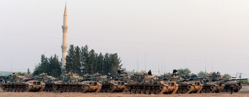 Turkish tanks stationed near the Syrian border, in Karkamis, Turkey, Saturday, Aug. 27, 2016. Turkey on Wednesday sent tanks across the border to help Syrian rebels retake the key Islamic State-held t ...