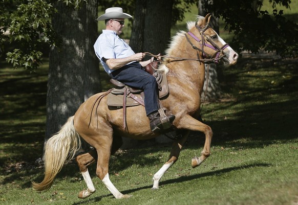 Former Alabama Chief Justice and U.S. Senate candidate Roy Moore rides in on a horse to vote at the Gallant Volunteer Fire Department during the Alabama Senate race, Tuesday, Sept. 26, 2017, in Gallan ...
