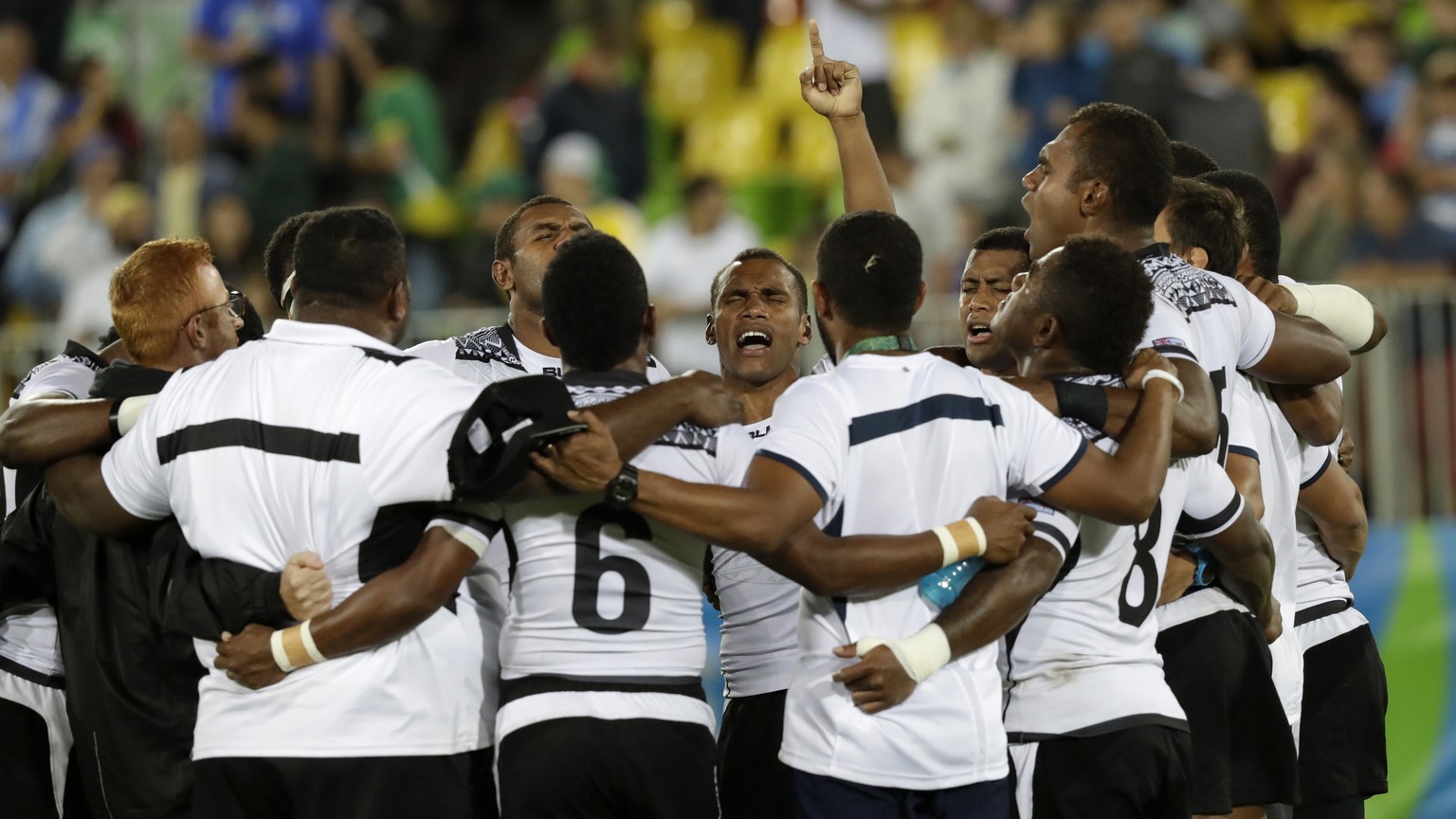 Fiji celebrates its the gold medal victory over Britain in mens rugby sevens at the 2016 Summer Olympics in Rio de Janeiro, Brazil, Thursday, Aug. 11, 2016. (AP Photo/Robert F. Bukaty)