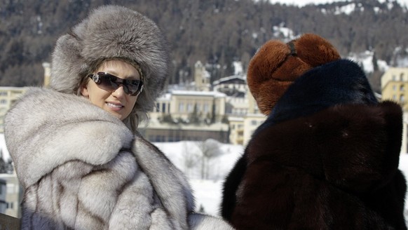 Visitors in fur coats enjoy the ambiance during the first weekend of the White Turf races in St. Moritz, Switzerland, Sunday, February 5, 2012. (KEYSTONE/Arno Balzarini)