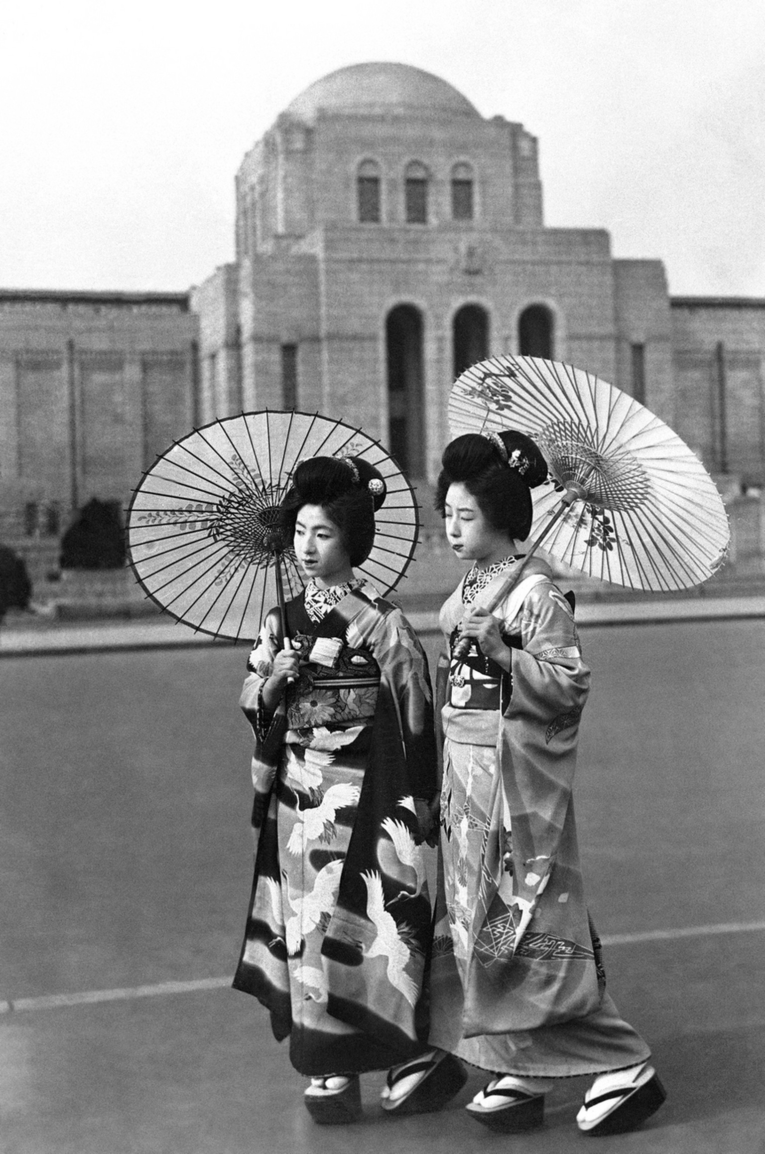 When Geisha girls open their guaze parasols and stroll the streets it is a sure sign of spring in Tokyo, on April 12, 1937. (AP Photo)