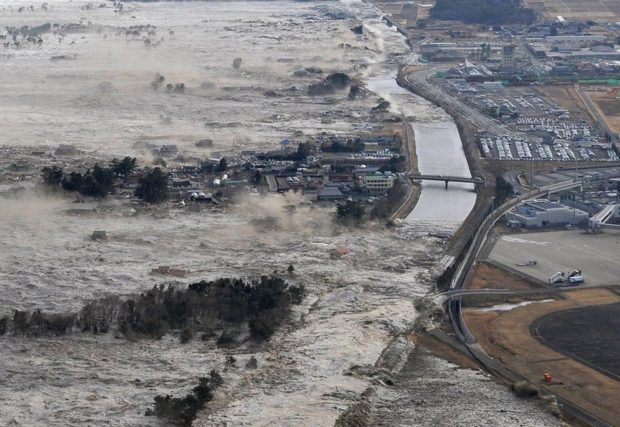 Earthquake-triggered tsumanis sweep shores along Iwanuma in northern Japan on Friday March 11, 2022. The magnitude 8.9 earthquake slammed Japan&#039;s eastern coast Friday, unleashing a 13-foot (4-met ...