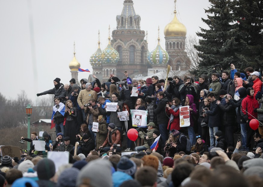 Protesters gather at Marsivo Field in St.Petersburg, Russia, Sunday, March 26, 2017. Thousands of people crowded in St.Petersburg on Sunday for an unsanctioned protest against the Russian government,  ...