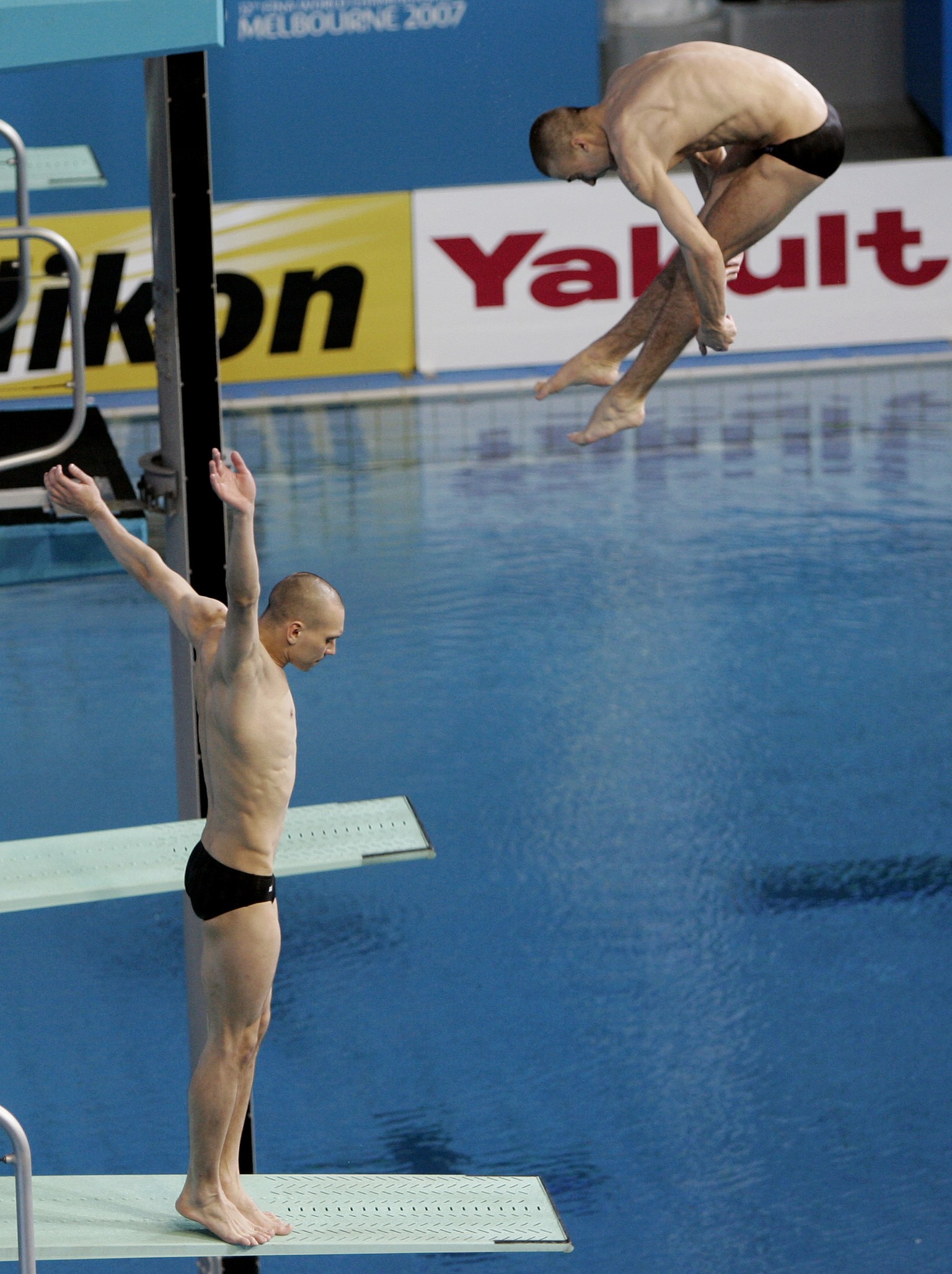Russian diver Aleksandr Dobroskok left, fails to dive as partner Gleb Galperin completes their routine during the final of the men's 3-meter synchro springboard event at the World Swimming Champi ...
