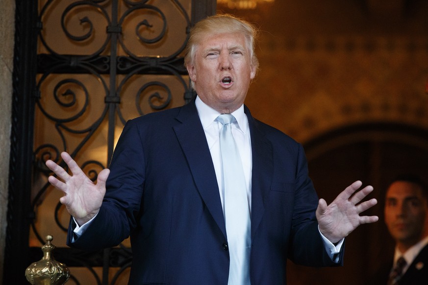 FILE - In this Wednesday, Dec. 28, 2016, file photo, President-elect Donald Trump speaks to reporters at Mar-a-Lago in Palm Beach, Fla. Trump has singled out a number of companies individually, includ ...