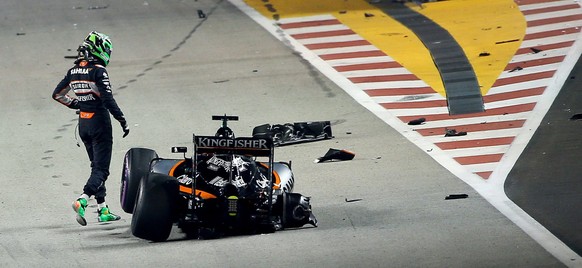 epa05545920 German Formula One driver Nico Hulkenberg of Sahara Force India F1 Team climbs out of his car after crashing out at the start of the Singapore Formula One Grand Prix night race in Singapor ...