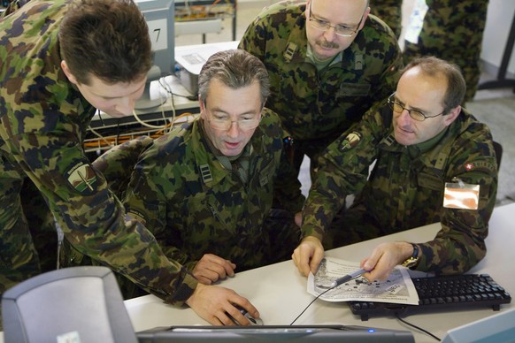 Swiss army officers work on the computer-based leadership information system (FIS) during the &quot;STABILO 08&quot; exercise in a bunker in Berne, Switzerland, pictured on August 19, 2008. Apart from ...