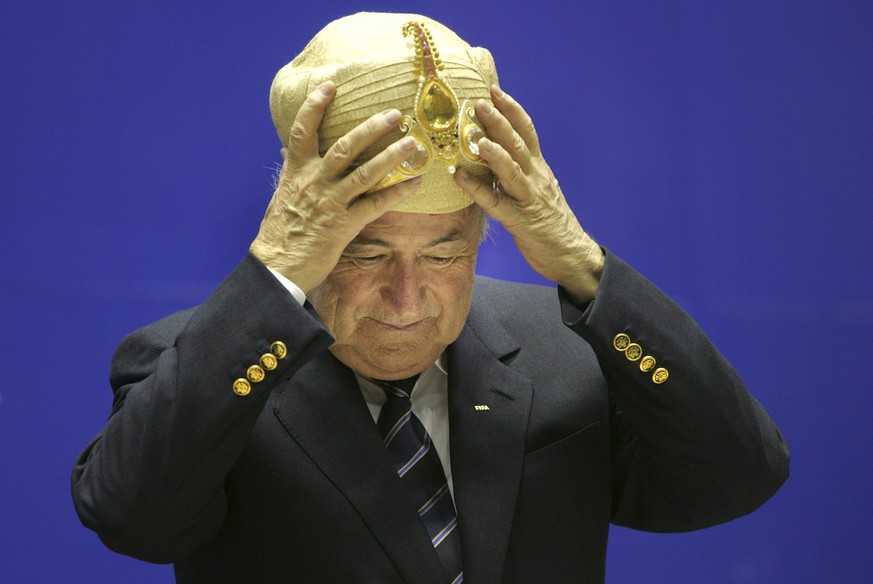 FILE - In this Tuesday, April 17, 2007 file photo FIFA, President Joseph Sepp Blatter, gestures after being presented with a traditional Indian headgear at the 70th Anniversary of Indian Football, in  ...