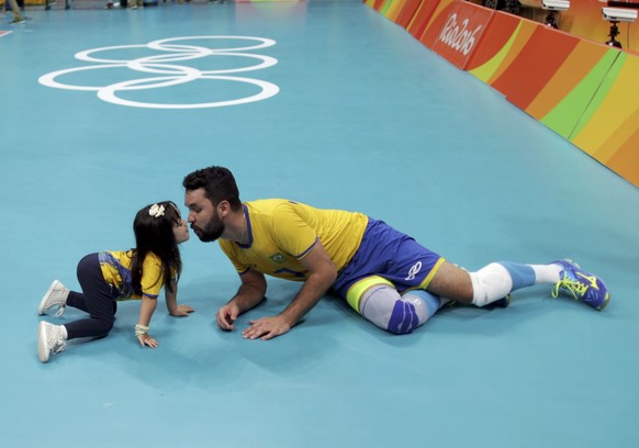 2016 Rio Olympics - Volleyball - Men&#039;s Semifinals Russia v Brazil - Maracanazinho - Rio de Janeiro, Brazil - 19/08/2016. William (BRA) of Brazil celebrates with his daughter after winning the mat ...