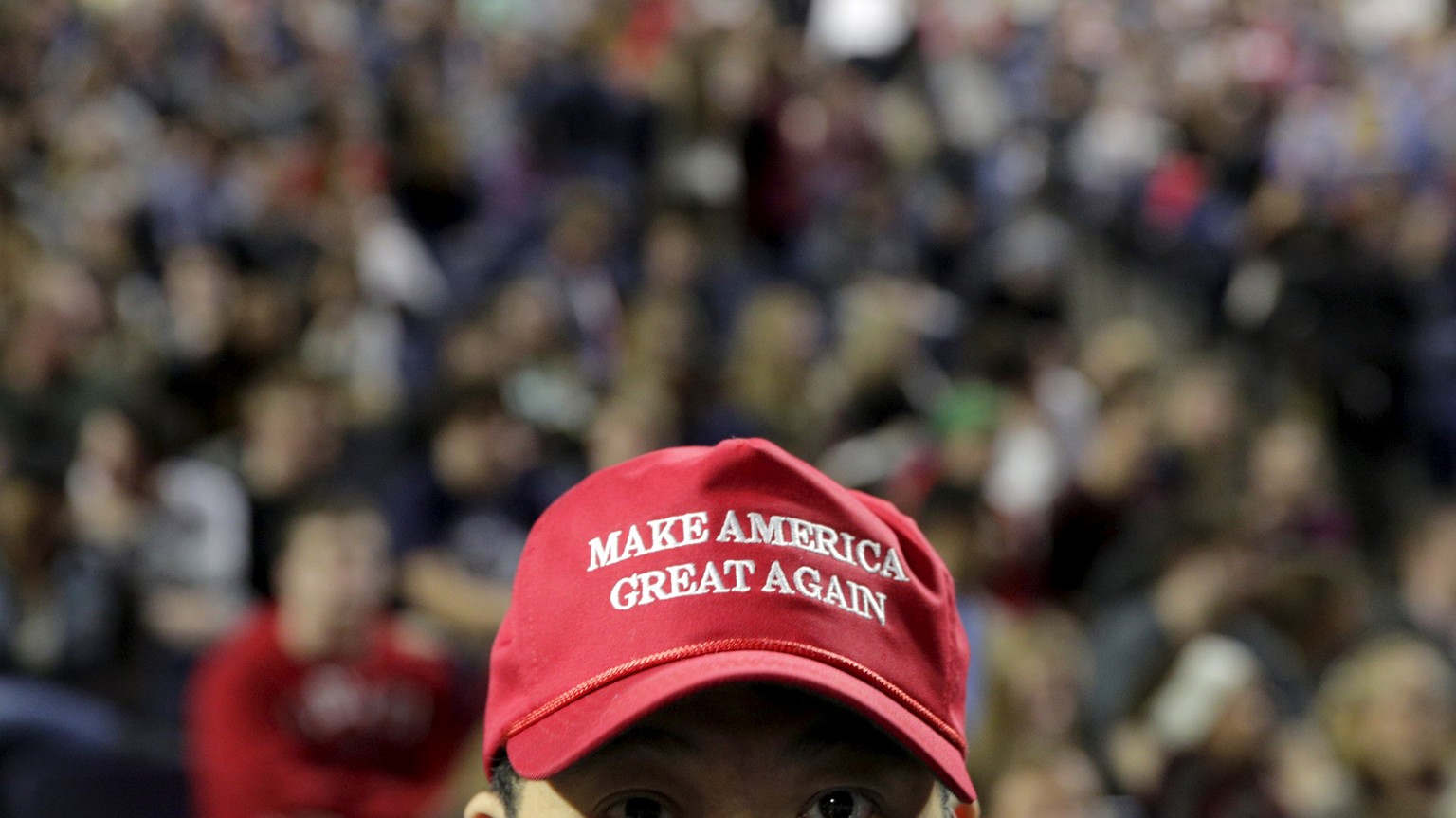 A supporter of U.S. Republican presidential candidate Donald Trump wears a &quot;Make America Great Again&quot; cap before his speech at Liberty University in Lynchburg, Virginia, January 18, 2016. RE ...