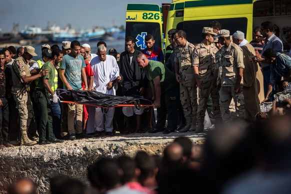 Egyptian coast guard and rescue workers bring ashore a body from a Europe-bound boat that capsized off Egypt’s Mediterranean coast, in Rosetta, Egypt, Thursday, Sept. 22, 2016. According to the Egypti ...