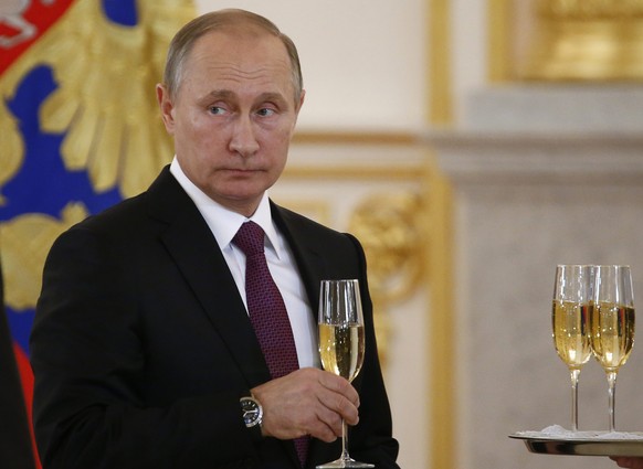 epa05624146 Russian President Vladimir Putin holds a glass during a ceremony of receiving diplomatic credentials from foreign ambassadors at the Kremlin in Moscow, Russia, 09 November 2016. EPA/SERGEI ...