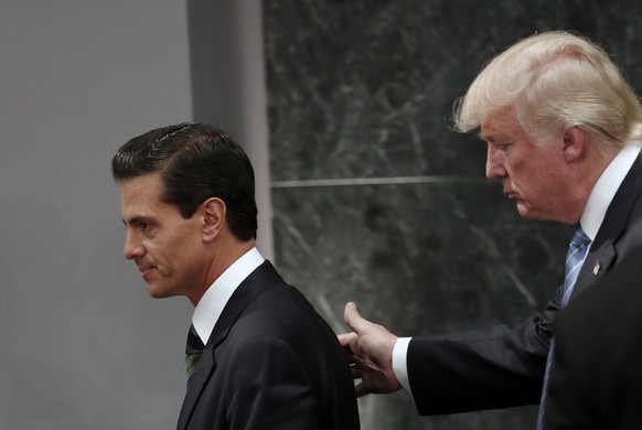 FILE - In this Aug. 31, 2016 file photo, Republican presidential nominee Donald Trump walks with Mexico President Enrique Pena Nieto at the end of their joint statement at Los Pinos, the presidential  ...