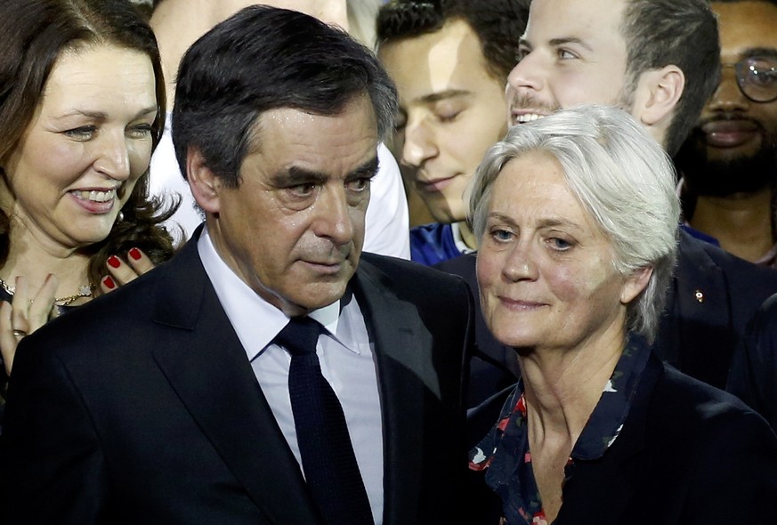 FILE PHOTO - Francois Fillon (L), former French prime minister, member of The Republicans political party and 2017 presidential candidate of the French centre-right, and his wife Penelope Fillon stand ...