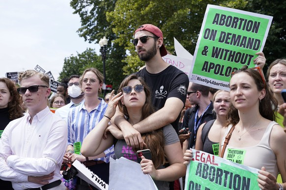 People react following Supreme Court&#039;s decision to overturn Roe v. Wade in Washington, Friday, June 24, 2022. The Supreme Court has ended constitutional protections for abortion that had been in  ...