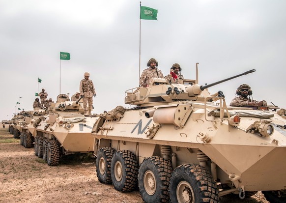 epa05190693 A handout photograph released by the official Saudi Press Agency (SPA) shows Saudi soldiers on armored vehicles during the multi-national military exercise &#039;North Thunder, at an undis ...