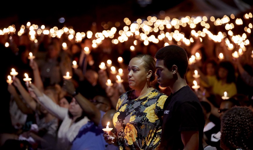 Veronica Hartfield, stands with her son, Ayzayah Hartfield during a candlelight vigil for her husband, Las Vegas police officer Charleston Hartfield, Thursday, Oct. 5, 2017, in Las Vegas. Hartfield wa ...