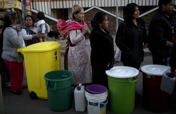People line up to collect water, distributed by the military police on a street in La Paz, Bolivia, Monday, Nov. 21, 2016. Bolivian President Evo Morales has declared a national emergency over a lack  ...