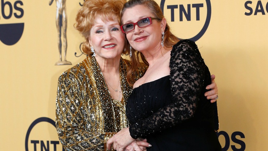 FILE PHOTO: Actress Debbie Reynolds poses with her daughter actress Carrie Fisher backstage after accepting her Lifetime Achievement award at the 21st annual Screen Actors Guild Awards in Los Angeles, ...