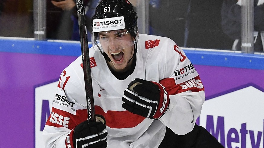 epa05962321 Switzerland’s Fabrice Herzog celebrates after scoring the winning goal during the IIHF Ice Hockey World Championship 2017 group B preliminary round game between Canada and Switzerland, in  ...