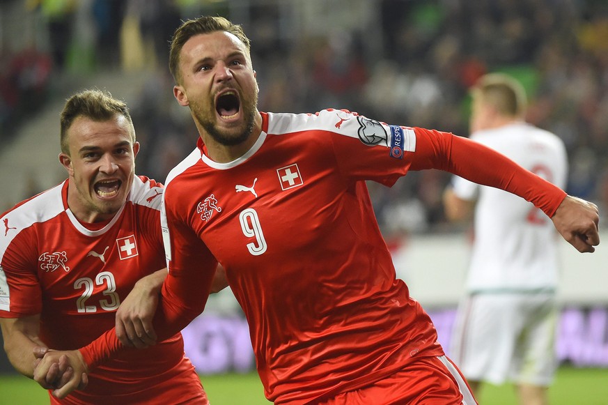 epa05575433 Haris Seferovic (R) celebrates with team-mate Xherdan Shaqiri after scoring the 1-0 lead during FIFA World Cup 2018 qualification soccer match between Hungary and Switzerland at the Groupa ...
