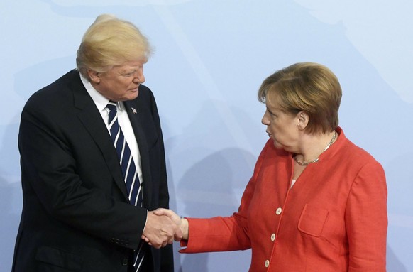 epa06072154 German Chancellor Angela Merkel (R) officially welcomes US President Donald J. Trump (L) to the opening day of the G20 summit in Hamburg, Germany, 07 July 2017. The G20 Summit (or G-20 or  ...