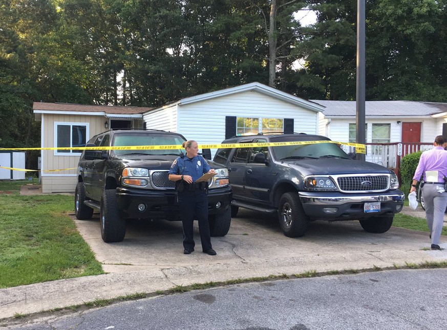 In this photo provided by the Gwinnett County Police Department, emergency personnel work at the scene where police found multiple people stabbed to death in Loganville, Ga., Thursday, July 6, 2017. ( ...