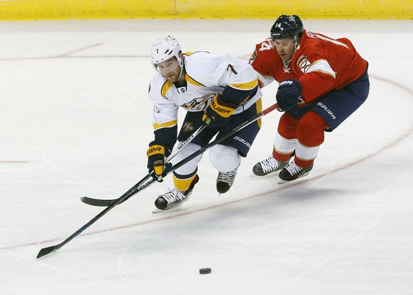 Nashville Predators defenseman Yannick Weber (7) and Florida Panthers forward Justin Fontaine (14) battle for the puck during the first period of an NHL hockey preseason game, Tuesday, Sept. 27, 2016, ...