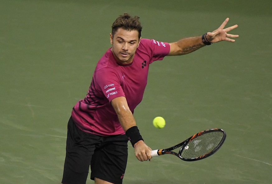 Stanislas Wawrinka, of Switzerland, returns a shot to Dominic Thiem, of Austria, at the BNP Paribas Open tennis tournament, Thursday, March 16, 2017, in Indian Wells, Calif. (AP Photo/Mark J. Terrill)