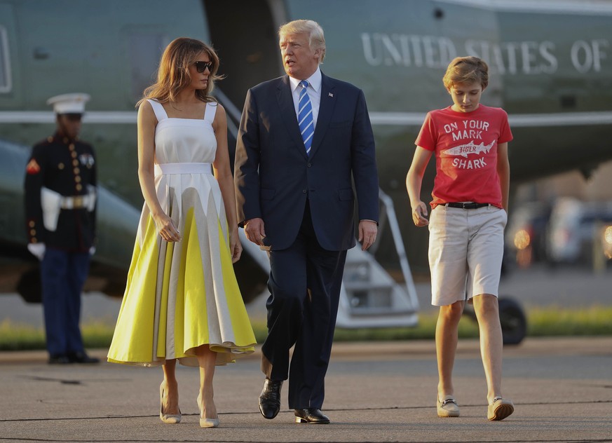 President Donald Trump, first lady Melania Trump and son Barron Trump walk across the tarmac before boarding Air Force One at Morristown Municipal Airport, Sunday, Aug. 20, 2017, in Morristown, N.J.,  ...