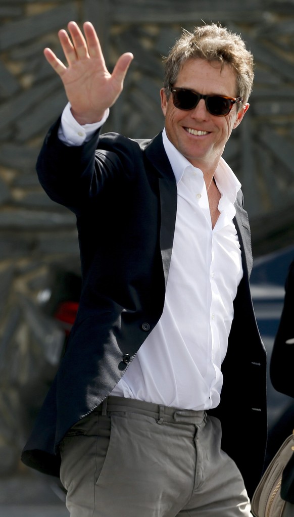 epa05546128 British actor and cast member Hugh Grant waves to fans upon his arrival for the presentation of the film &#039;Florence Foster Jenkins&#039; in the 64th edition of the San Sebastian Intern ...
