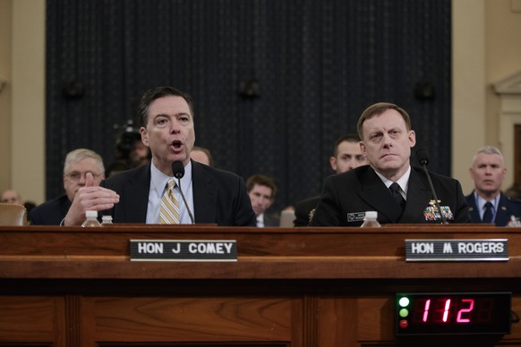 FBI Director James Comey, left, joined by National Security Agency Director Michael Rogers, right, testifies on Capitol Hill in Washington, Monday, March 20, 2017, before the House Intelligence Commit ...