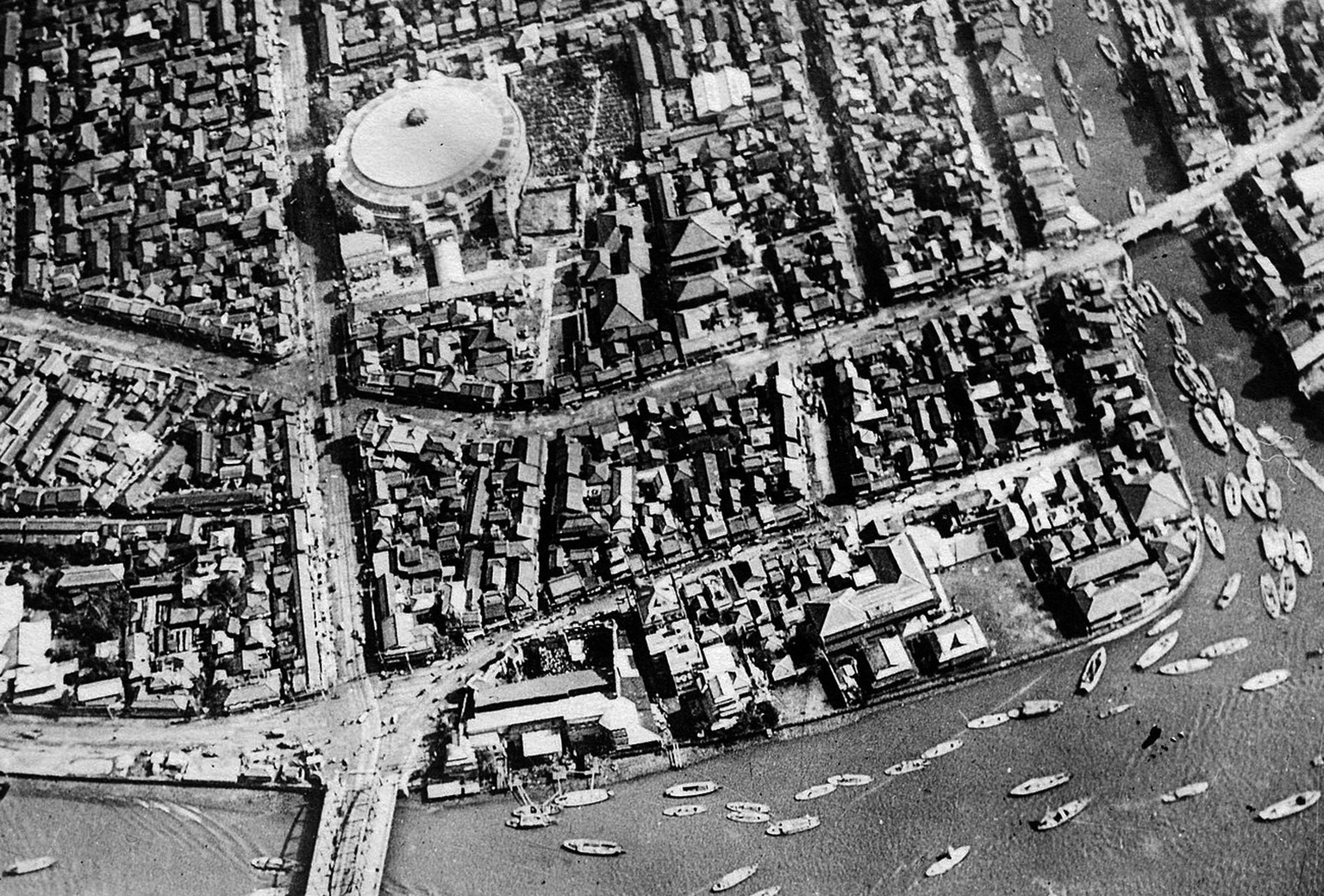 TOKYO, Japan - This aerial photo taken in 1922 shows an area around former building of Ryogoku Kokugikan in Tokyo. At the bottom is the Sumida River, on which many boats can be seen floating. (Kyodo)