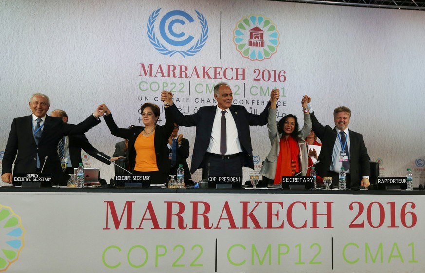 U.N. climate chief Patricia Espinosa (2nd L), Morocco&#039;s Foreign Minister Salaheddine Mezouar (C), and Council of Europe Goodwill Ambassador Bianca Jagger (2nd R) celebrate after the proclamation  ...