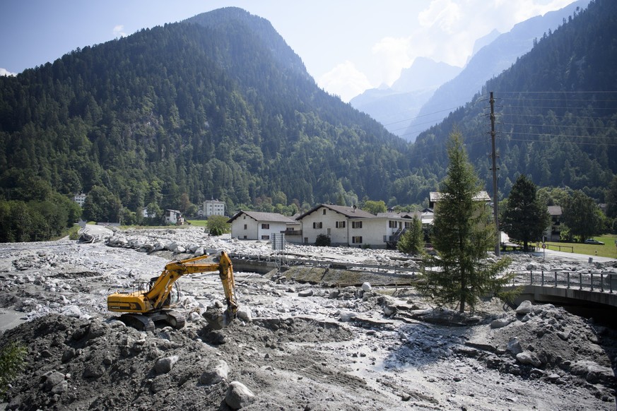 epa06161883 An excavator works on the landslide in Bondo, Graubuenden in southern Switzerland, 25 August 2017. The village had been hit by a massive landslide on Wednesday. The main road between Stamp ...