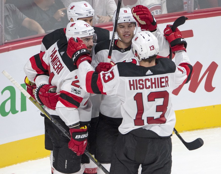 New Jersey Devils center Nico Hischier (13) celebrates with teammates Kyle Palmieri (21), Dalton Prout (5) and Taylor Hall (9) after scoring during first period an NHL preseason hockey game against th ...