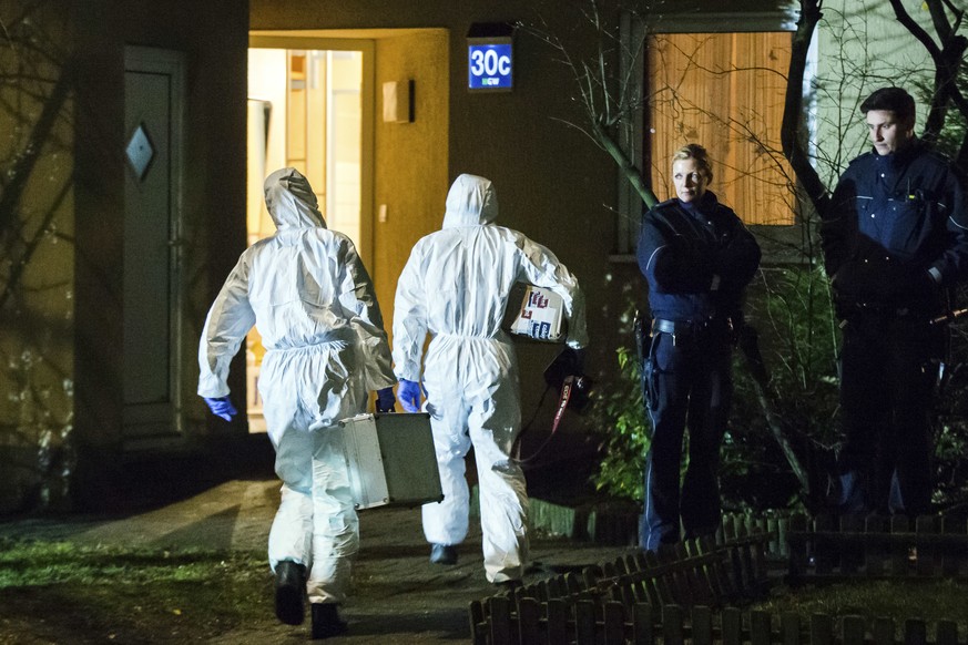 Forensic scientists enter a house in Herne, Germany, Tuesday, March 7, 2017. German police said Tuesday they have launched a manhunt for a 19-year-old man who allegedly killed a 9-year-old boy in the  ...